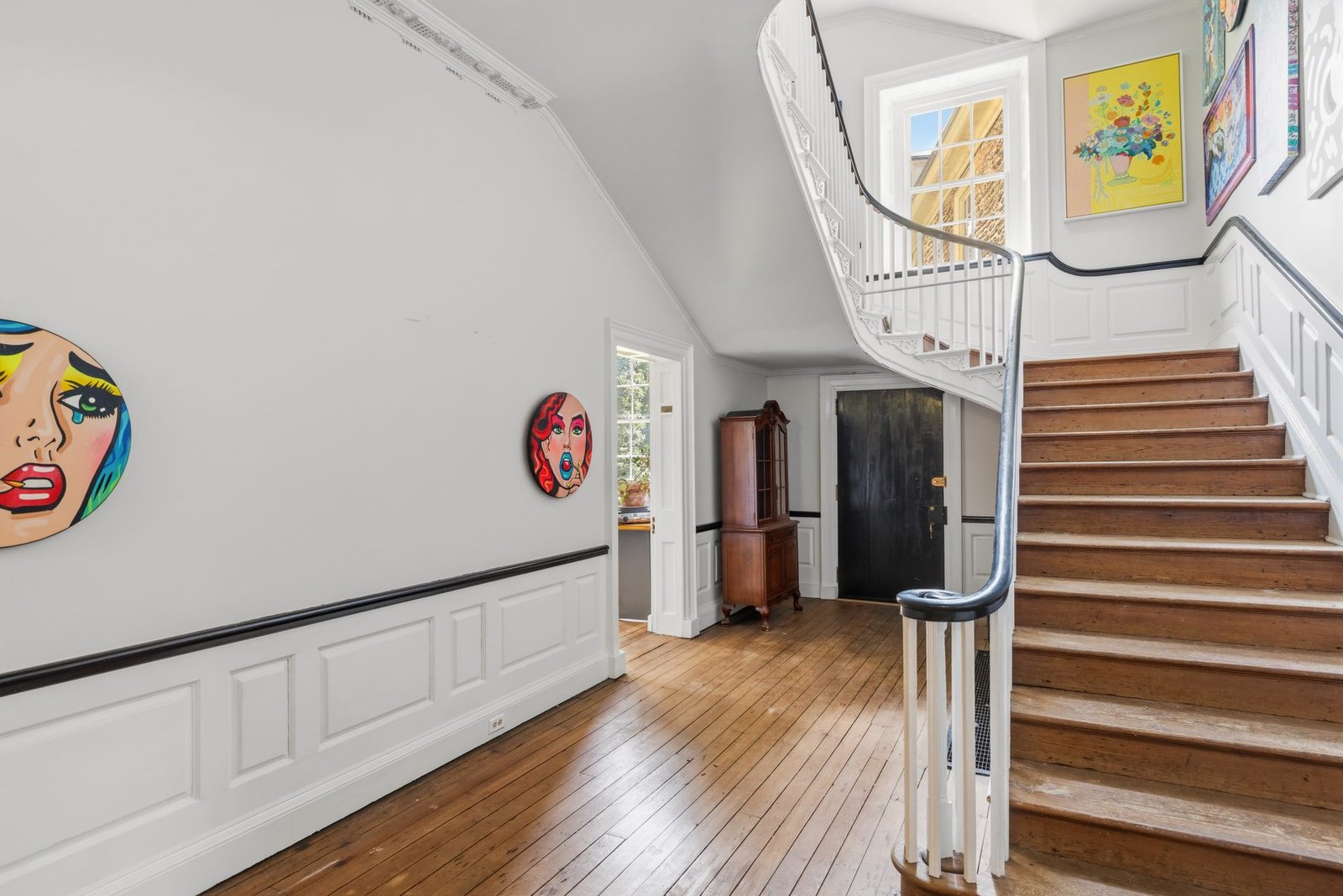 The grand spiral staircase inside Upsala Mansion, rising through multiple floors